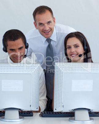 Manager talking to a man and woman in a call canter