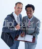 Smiling businessmen writing in a business diary