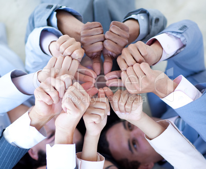 Close-up of business team on floor in a circle with thumbs up