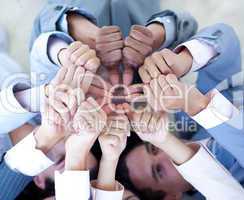 Close-up of business team on floor in a circle with thumbs up