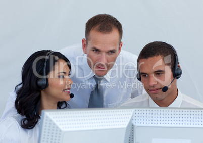 Manager helping business people in a call canter
