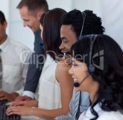 Business team working in a call center with a manager