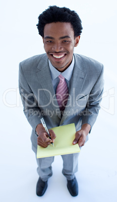 High angle of businessman writing notes