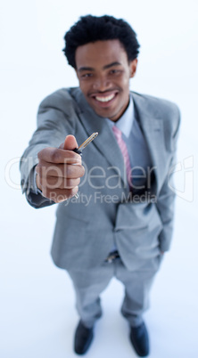 Afro-American businessman holding a key. Property concept