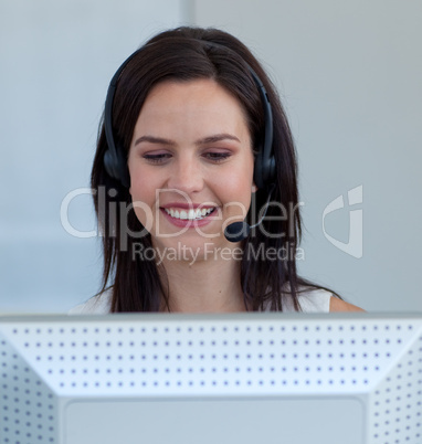 Beautiful businesswoman in a call centre with a headset on