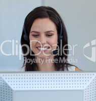 Beautiful businesswoman in a call centre with a headset on