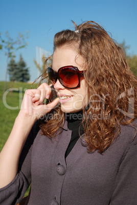 girl speaks by phone in the afternoon