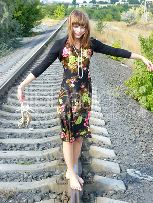beautiful undressed girl goes on tracks home