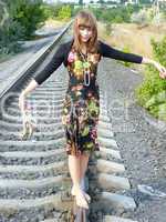beautiful undressed girl goes on tracks home