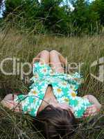 beautiful young girl lies on a grass