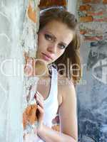 brown-haired woman  is on the disorganised building