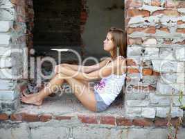 brown-haired woman  sits on building