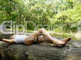 girl dreams on a log in wood