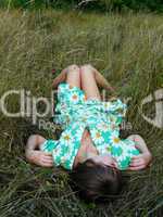 sexyal and beautiful young girl lies on a grass