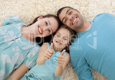 Parents and little girl on floor with thumbs up