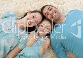 Parents and daughter on floor with thumbs up