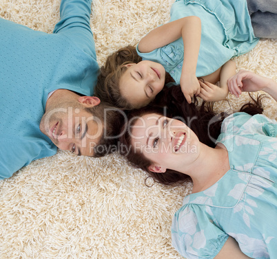 Parents and daughter on floor with heads together