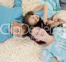 Parents and daughter on floor with heads together