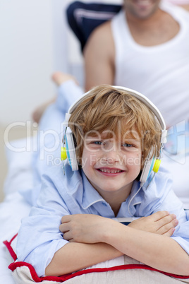 Portrait of a little boy listening to music in bedroom