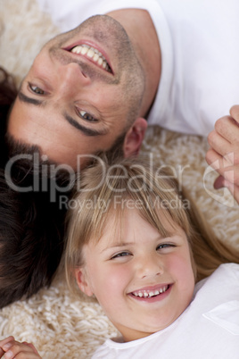 Portrait of father and daughter on floor with heads together