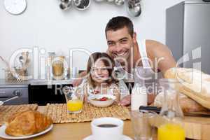 Daughter having breakfast with her father