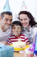 Little boy celebrating his birthday with his parents