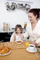 Daughter and mother having breakfast