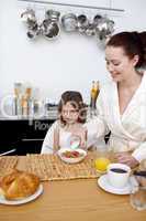 Daughter and mother in breakfast time