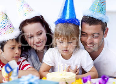 Little girl admiring a cake on her birthday's day