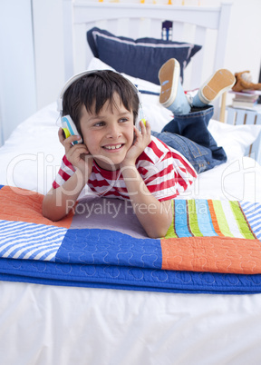 Happy boy listening to music with headphones on
