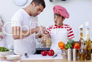 Boy hurt his finger cooking and father treating it
