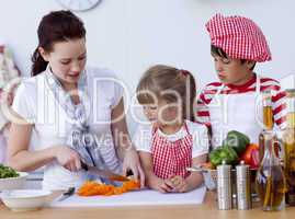 Children helping mother cooking in the kitchen