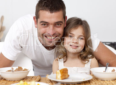 Portrait of father and daughter having breakfast