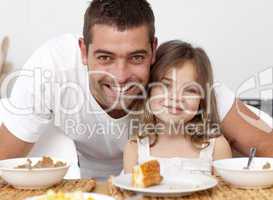 Portrait of father and daughter having breakfast