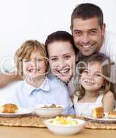 Portrait of happy family having breakfast