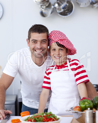 Father and son cooking a salad