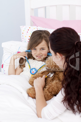 Mother and daughter playing with a stethoscope