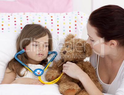 Sick daughter playing with a stethoscope with her mother