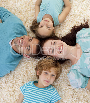 Happy family on floor with heads together