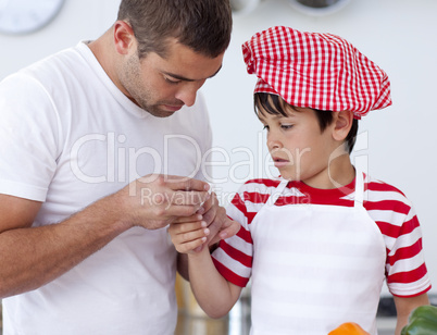 Boy hurt his finger and father treating it