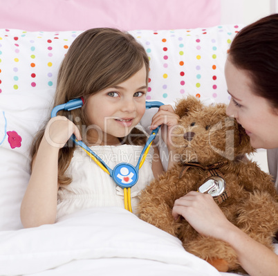 Portrait of a little girl playing with a stethoscope