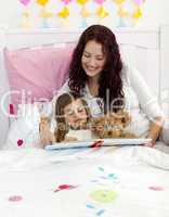 Mother and daughter reading in bedroom