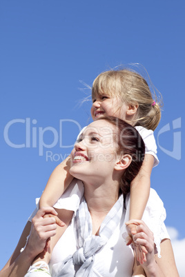 Mother giving her daughter piggyback ride