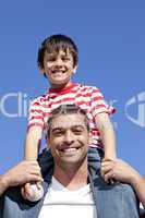 Father giving his son piggyback ride outdoors