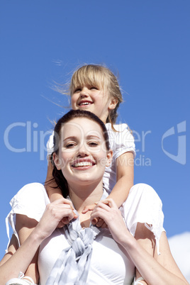 High angle of mother giving her daughter piggyback ride