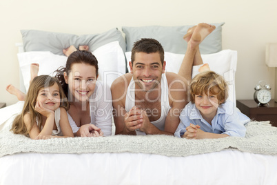 Family lying in bed with pyjamas