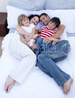 High view of family relaxing in bed