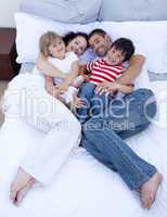 High view of family relaxing in bed