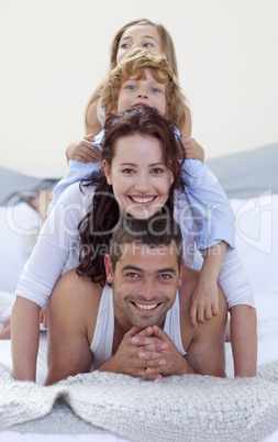 Father, mother, son and daughter in a mountain in bed