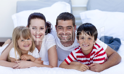 Portrait of family lying in bed together